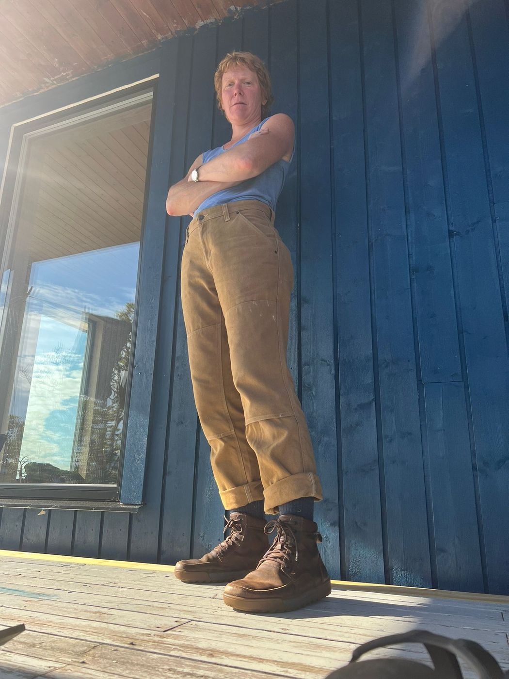 A caretaker standing on the deck with arms crossed