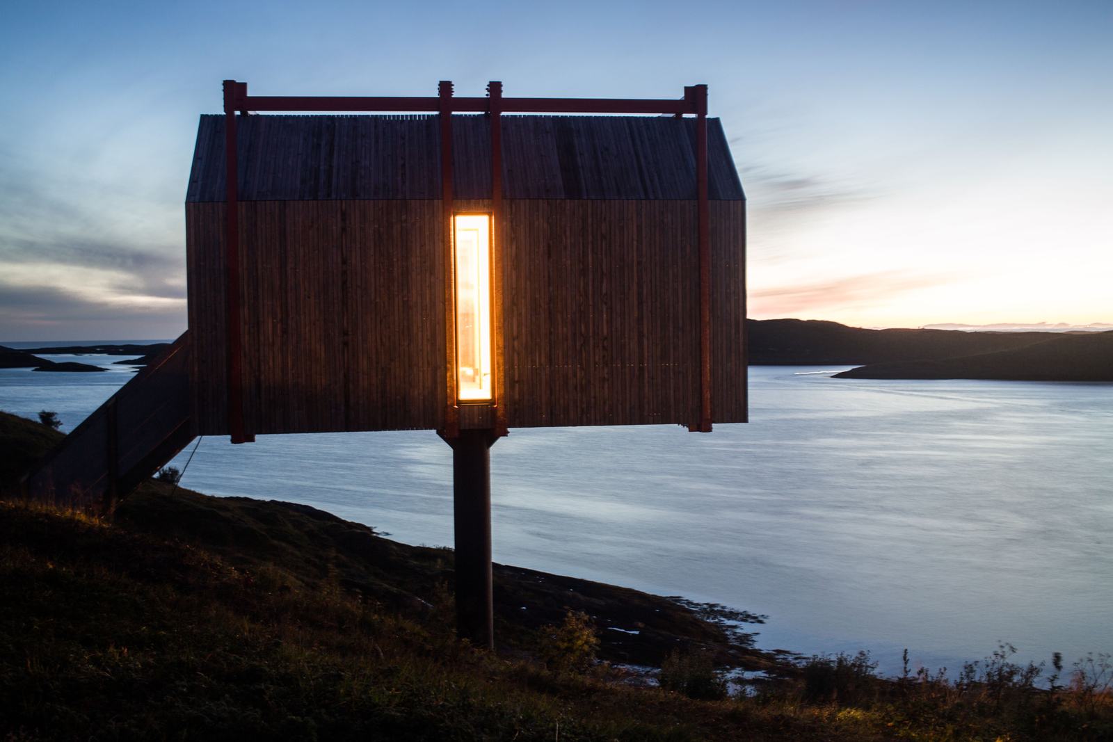 The Tower House at dusk with one lit window