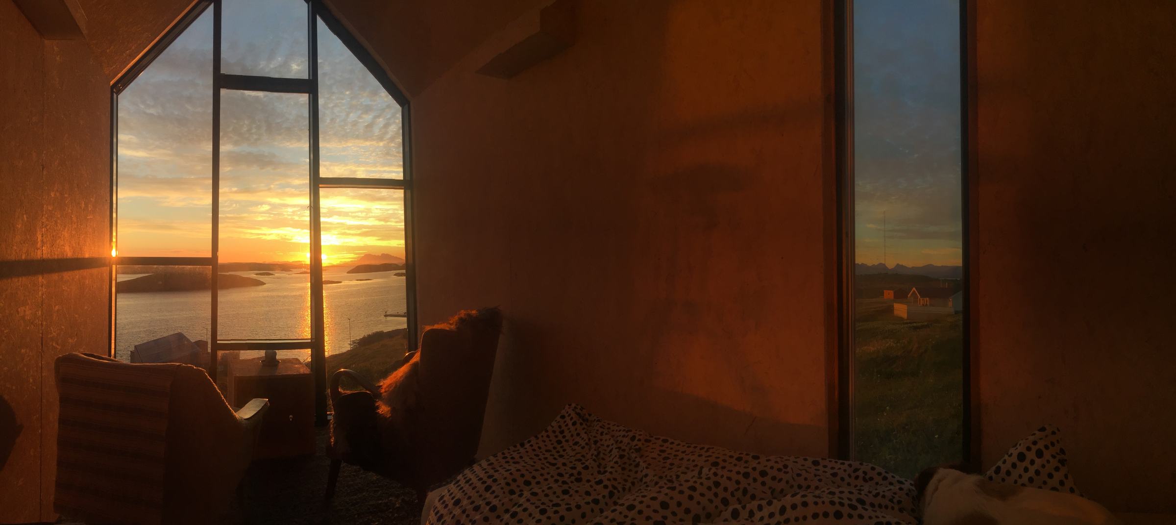 Inside the Tower House at sunset, low light through the gable window