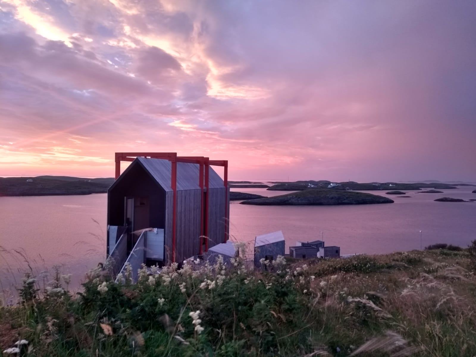 The Tower House against a pink sunset sky