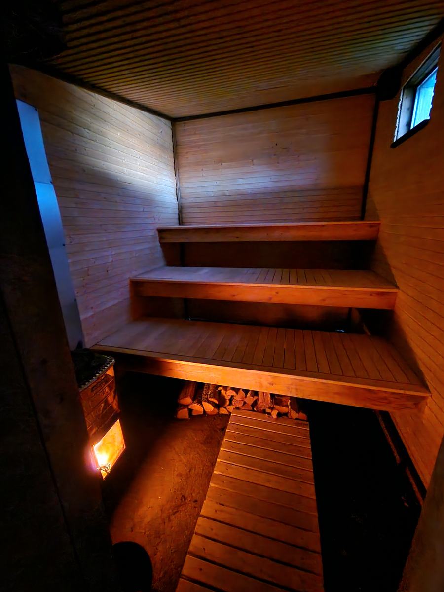 The wood-fired sauna, lit from within