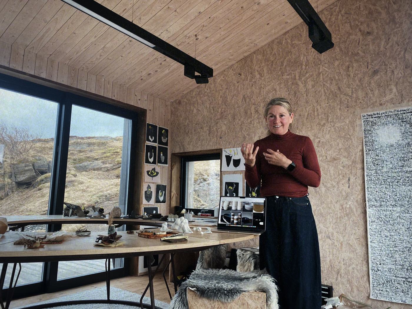 An artist presenting her work in the Studio House