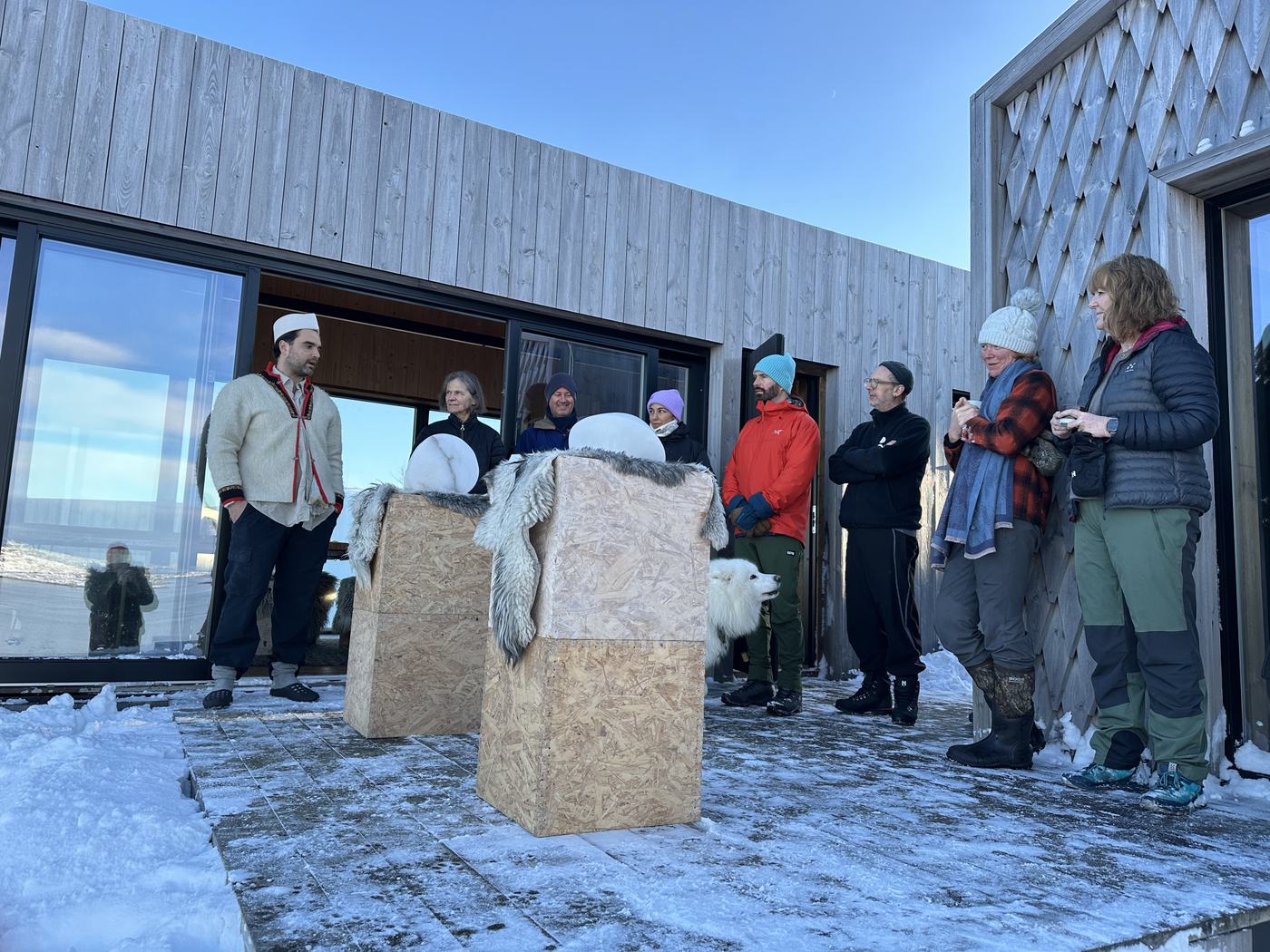 Thor presenting his sculptures to the islanders in the snow