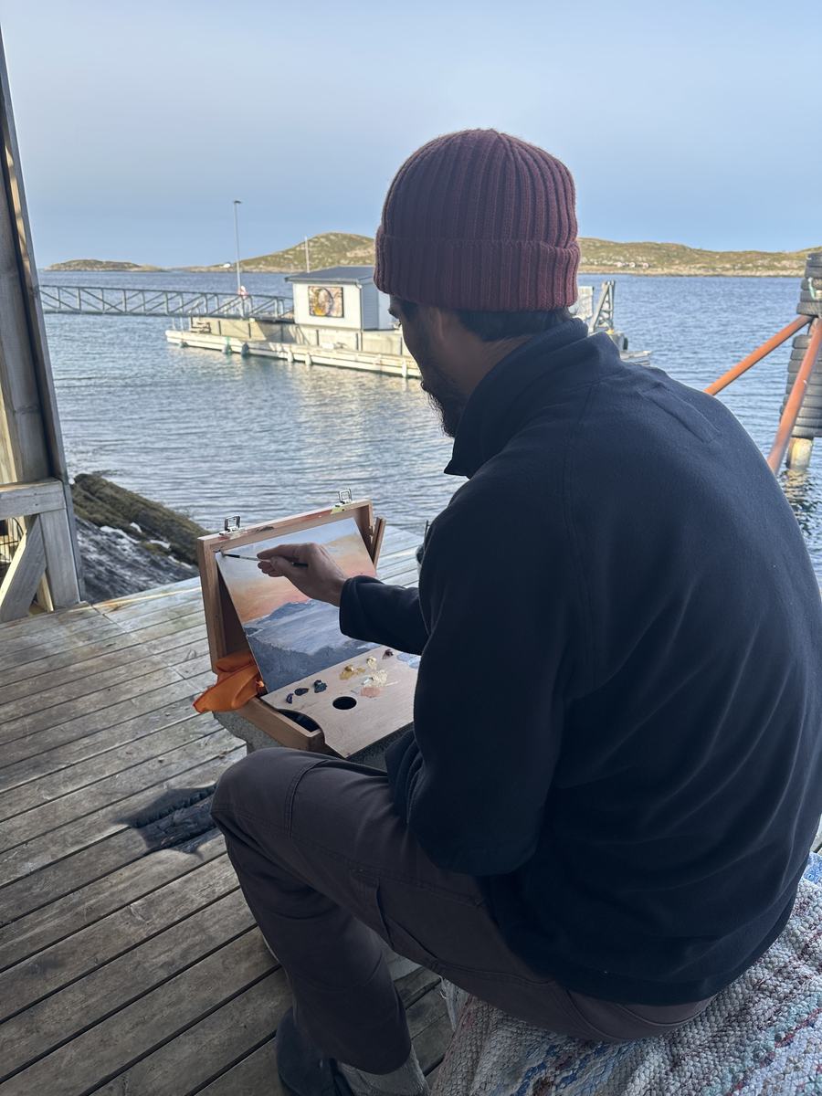 Eduardo painting on the deck of the Crab Trap