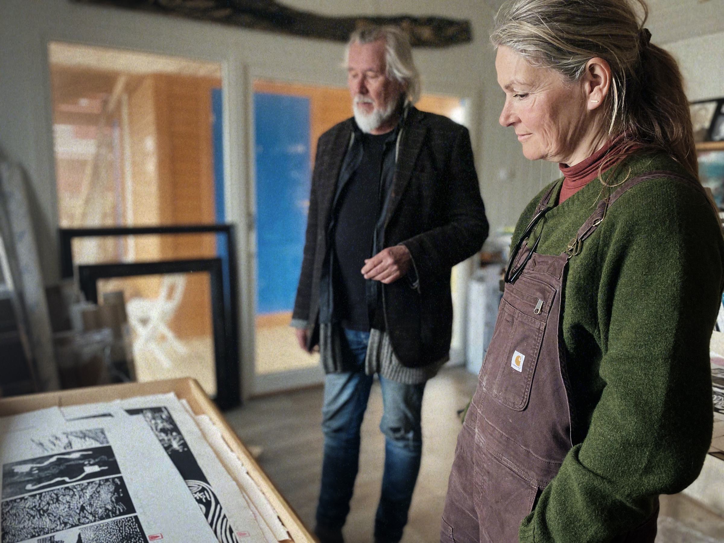 Two artists looking at prints in the Studio House
