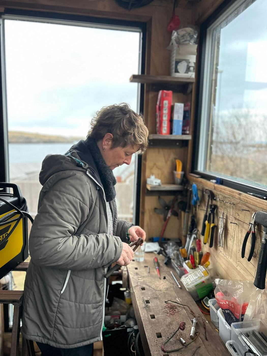 An artist working at the bench in the carpentry studio