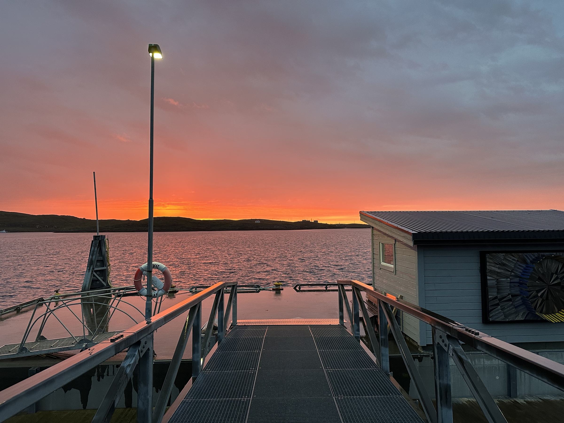 Sunset over the sea from the end of the pier