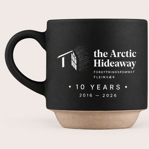 The black 10-year edition mug with The Arctic Hideaway logo